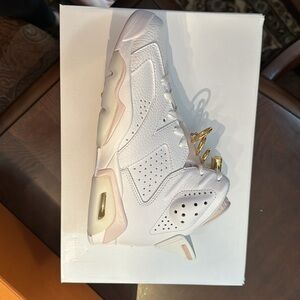 Brand New in box. Women's air Jordan 6 retro with pink and gold details.